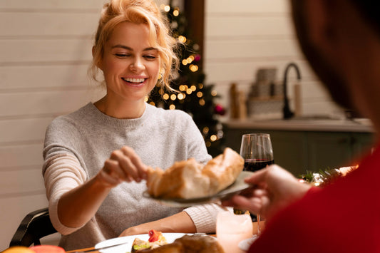 Woman enjoying a relaxed Christmas meal, reflecting a calm and balanced approach to digestion during the holidays.