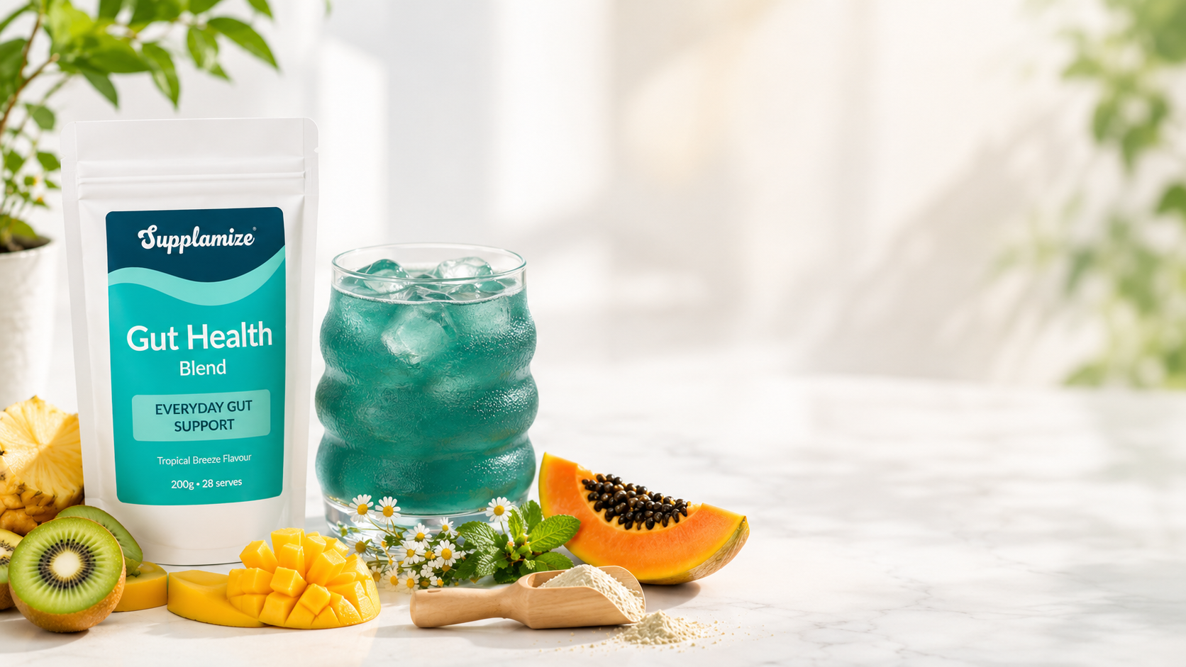 Supplement bottle labeled 'Gut Health Blend' with a glass of green liquid, fruits, and a plant on a light background.
