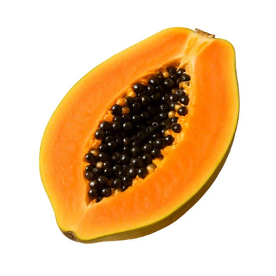 Halved papaya with black seeds on a white background